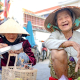 Two Smiling older-Vietnamese Women at a Market