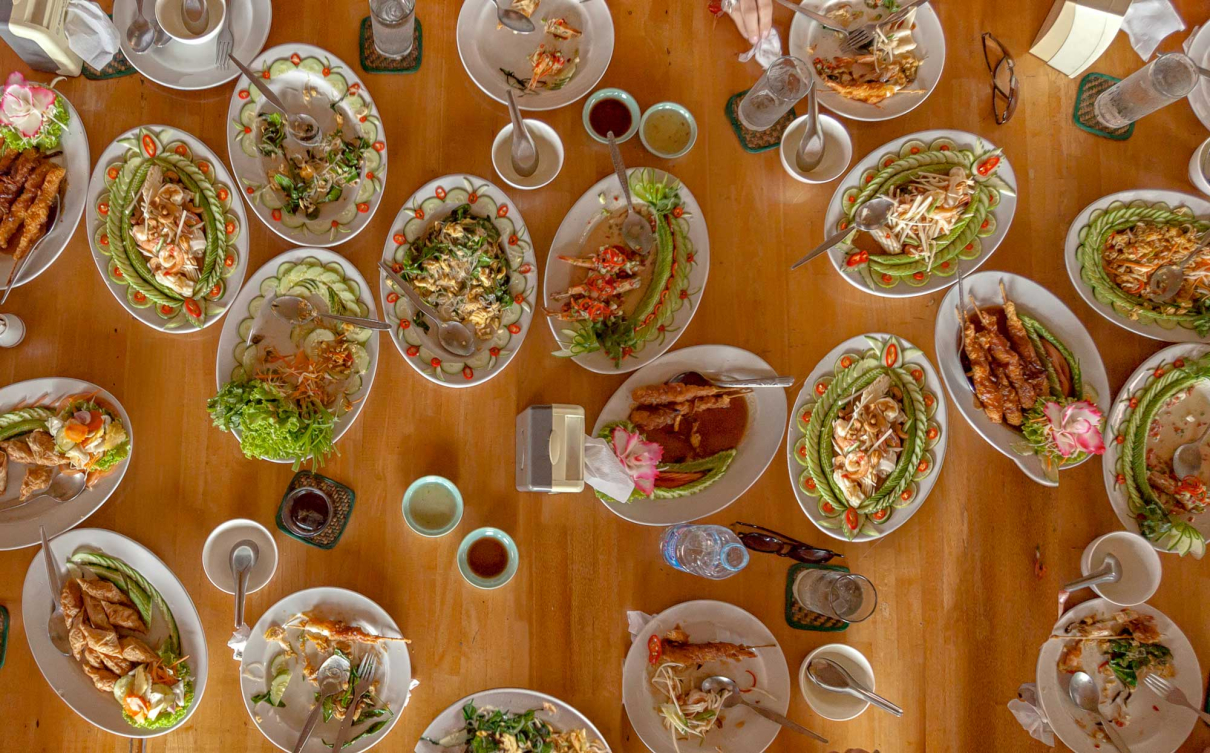 Table full of delicious Thai dishes.